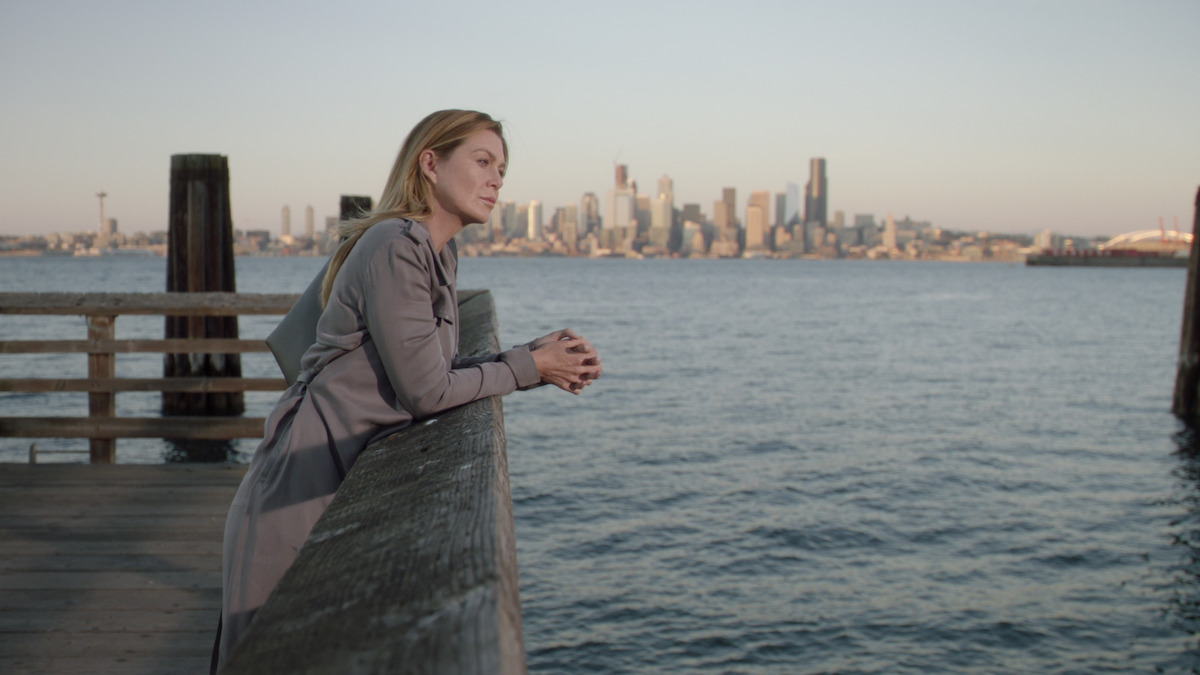 Meredith stares off into the distance from a pier