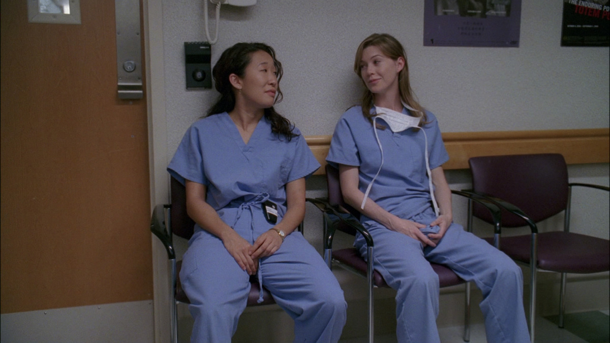 Cristina Yang and Meredith Grey sitting together at the hospital