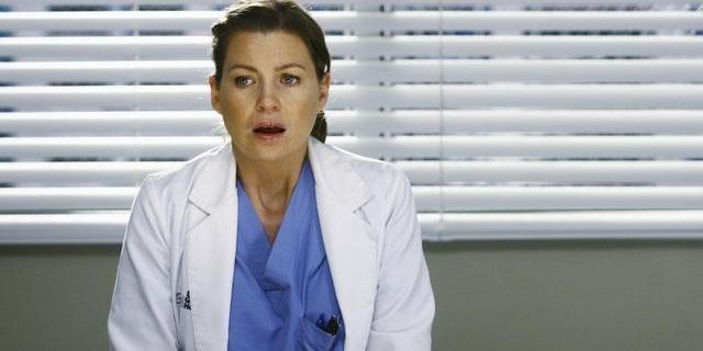 Ellen Pompeo as Meredith Grey standing in a hospital shocked in Now or Never, Grey's Anatomy episode