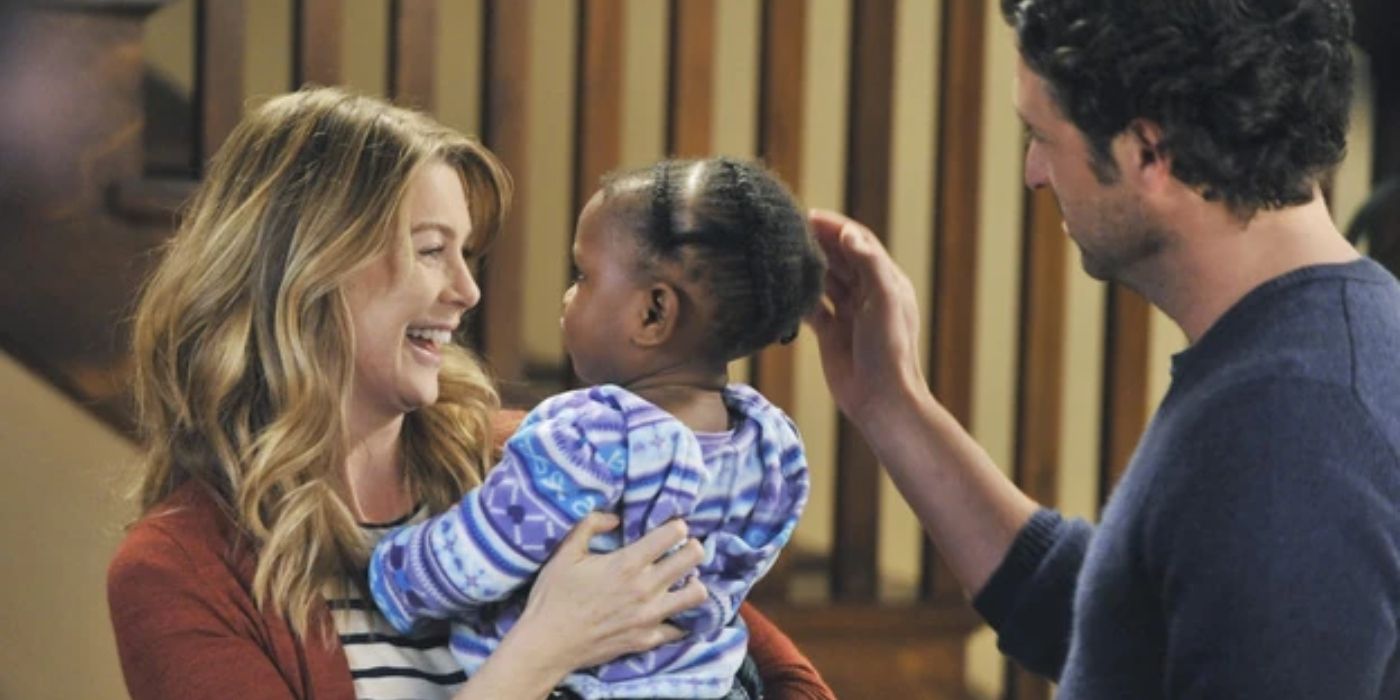 Ellen Pompeo and Patrick Dempsey as Meredith and Derek in Grey's Anatomy, holding Zola