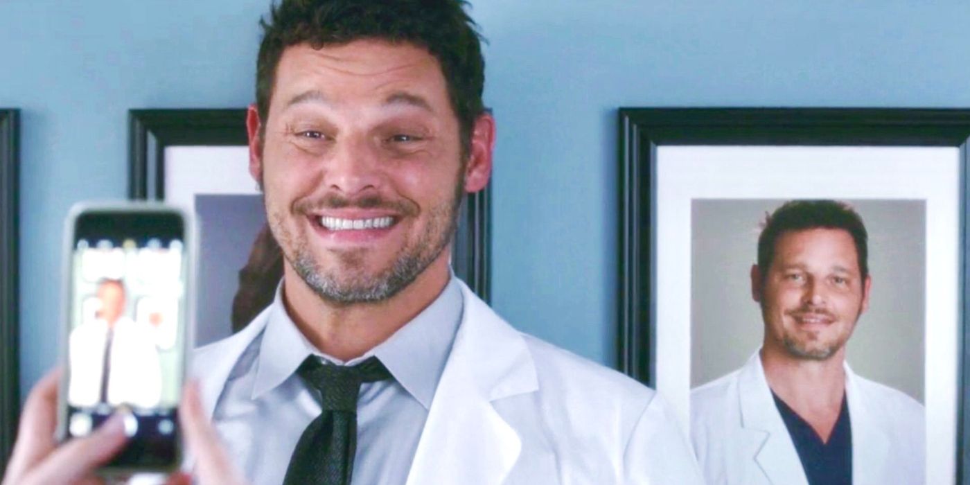 Justin Chambers as Alex Karev in Grey's Anatomy, smiling for picture in front of framed photo